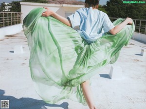 A collage of photos of a woman in a white shirt and green skirt.