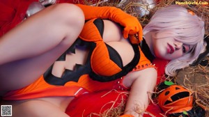 A woman laying on a bed covered in halloween decorations.