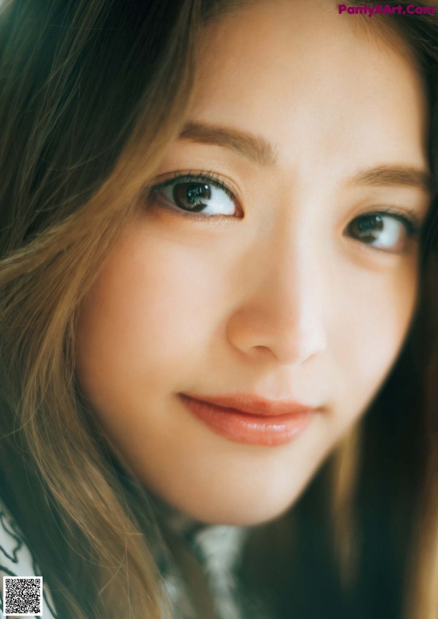 A close up of a woman with long brown hair.