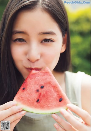 A magazine with a picture of a young woman smiling.