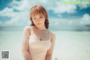 A magazine with a picture of a woman laying on the beach.