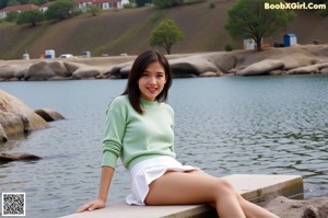 A woman in a white bra and panties posing for a picture.