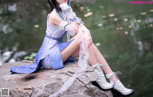 A woman in a blue and white outfit posing for a picture.