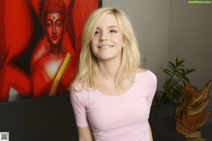A naked blonde woman holding a hula hoop in her hand.