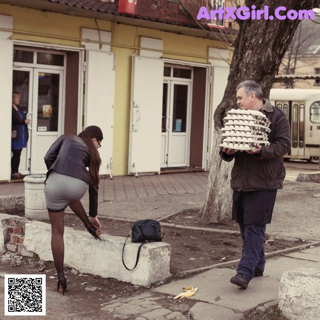 A man and a woman standing next to each other on a sidewalk.