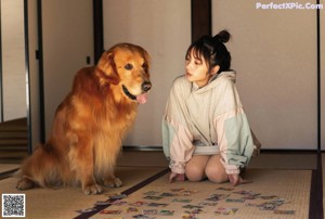 A woman sitting in a wooden box with a dog.