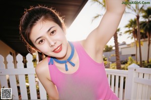 A woman in a blue bikini posing for the camera.