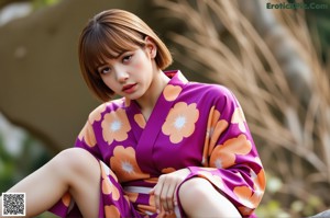 A woman sitting on a concrete ledge wearing a blue sweater and white shorts.