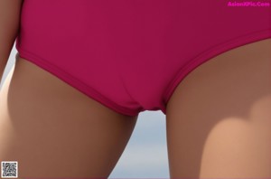 A woman in a pink shirt and blue bikini posing on a rock.