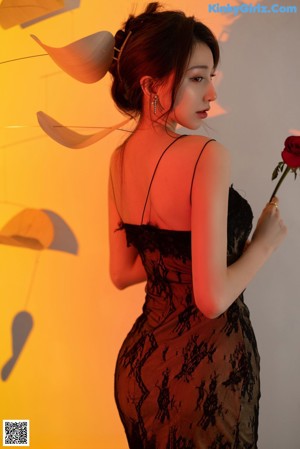 A woman in a white dress posing for a picture.